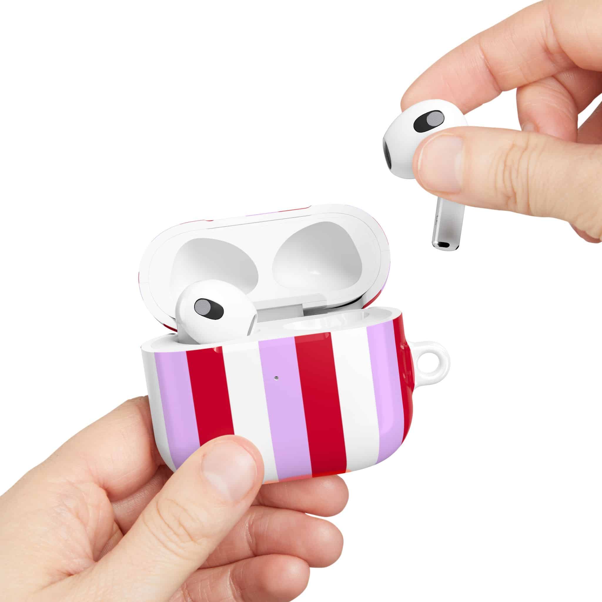 Wireless earbuds in a decorative charging case featuring purple and red vertical stripes, perfect for stylish audio accessories and portable Bluetooth earphones.