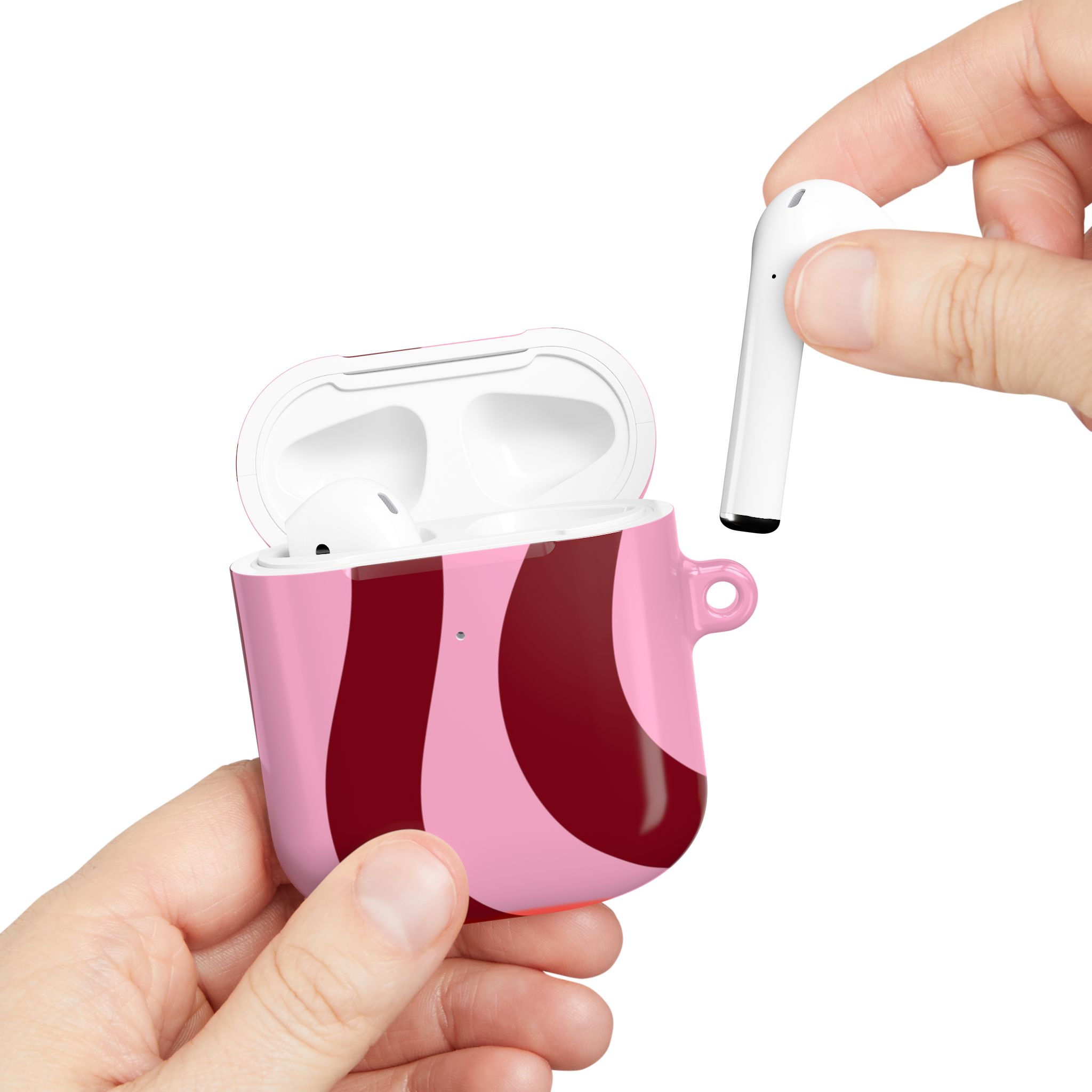 Wireless earbuds in a pink and red patterned charging case, with a hand holding one earbud, showcasing premium audio tech and stylish design for modern music lovers.